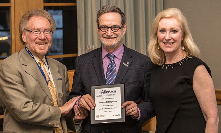 Dr. Howard Bergman receives a plaque of recognition